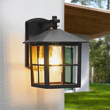 Outdoor wall light fixture on a house exterior with a blurred background