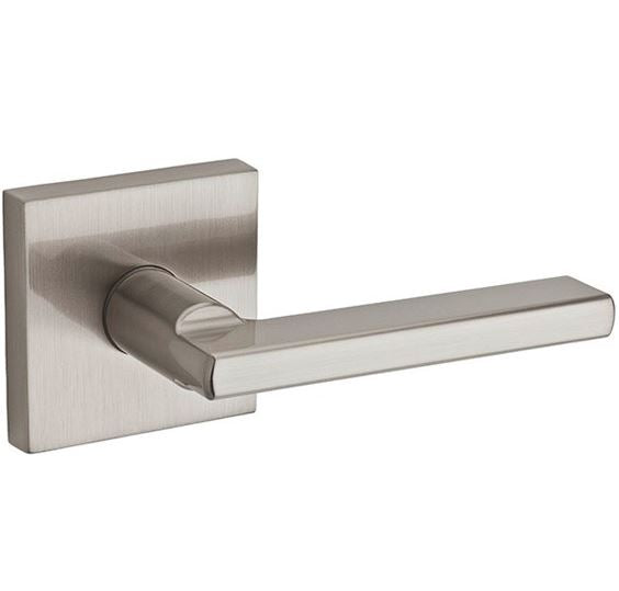 Kwikset halifax satin nickel passage door lever on a white background