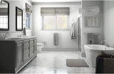 Modern bathroom with gray vanity, freestanding bathtub, and large window.