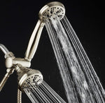 Shower head with water flowing against a black background