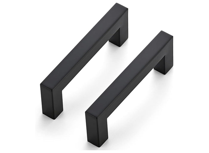Two black cabinet handles on a white background