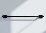 Black towel bar on a white wall