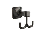 A wall-mounted, bronze finish robe hook with a geometric profile and twist details, from the Napier Collection.